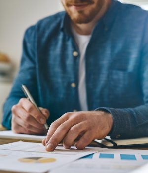 man doing financial work looking over personal savings account